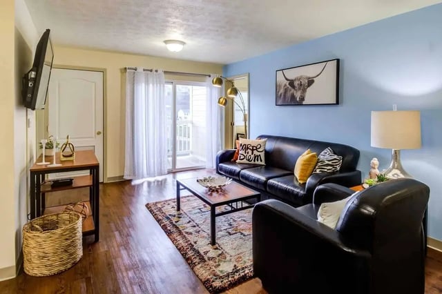 Black leather sofa rug and coffee table Living room at West Run Morgantown in Morgantown Student Accommodation