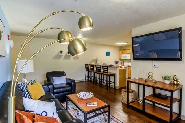 Leather sofa armchair coffee table kitchen living room at West Run Morgantown in Morgantown Student Accommodation