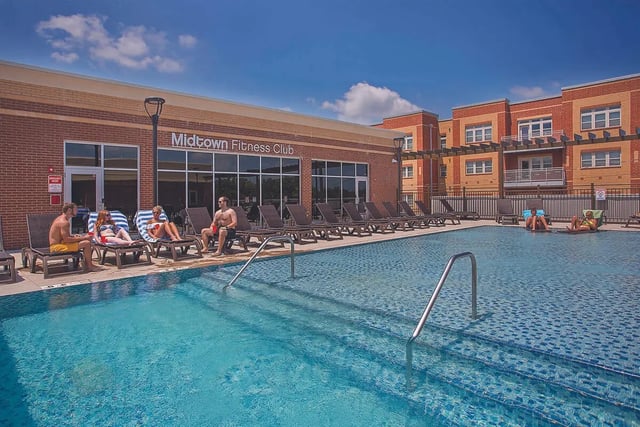 People relaxing by swimming pool exterior at Midtown at WKU in Bowling Green Student Accommodation