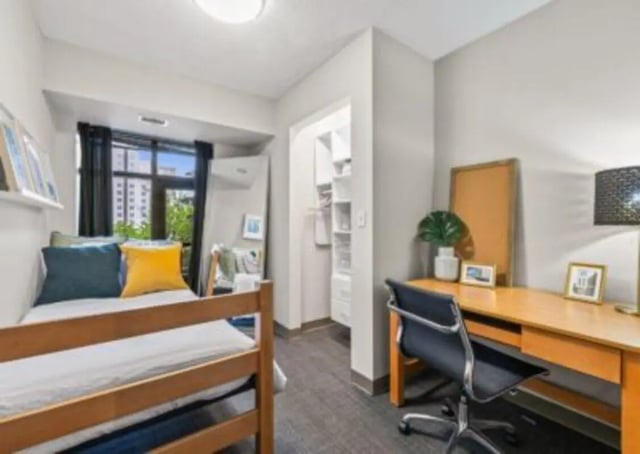 Bed desk and closet student room interior at University Center in Chicago Student Accommodation