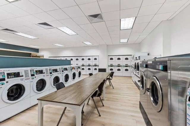Washing machines and dryers with seating area laundry room at University Center in Chicago Student Accommodation