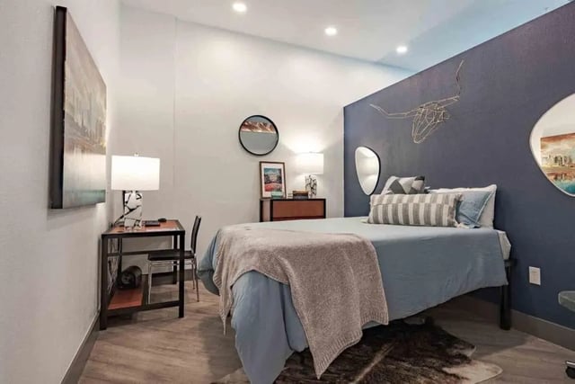 Bed desk chair artwork and lamp bedroom at Villas On Guadalupe in Austin Student Accommodation