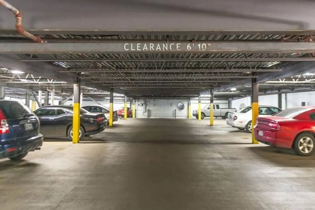 Cars parked under covered clearance exterior parking. at Villas On Guadalupe in Austin Student Accommodation