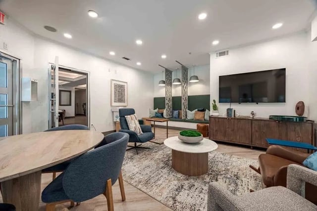 Seating table and television in communal living space at Villas On Guadalupe in Austin Student Accommodation