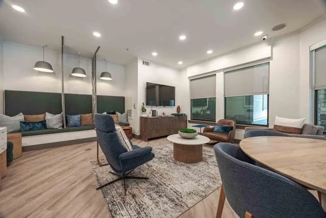 Seating area with chairs table and TV living room at Villas On Guadalupe in Austin Student Accommodation