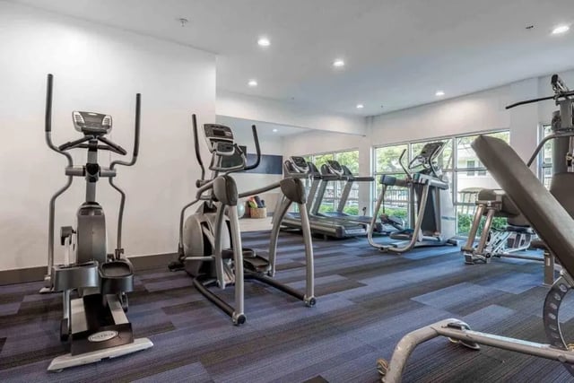 Ellipticals treadmills weight bench gym fitness area at Villas On Guadalupe in Austin Student Accommodation