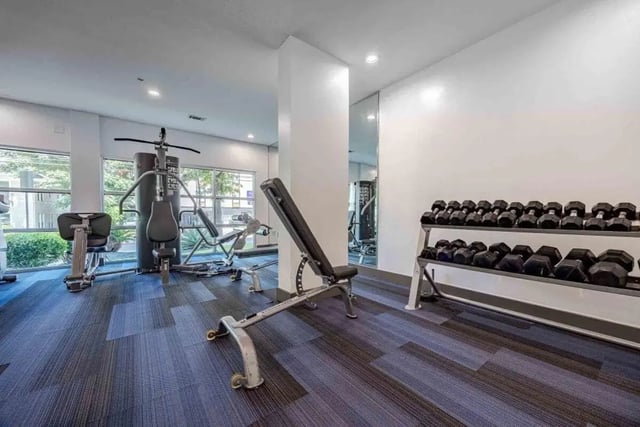 Gym equipment and dumbbells gym area at Villas On Guadalupe in Austin Student Accommodation