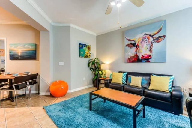 Black sofa with colorful pillows living room. at Villas On Guadalupe in Austin Student Accommodation