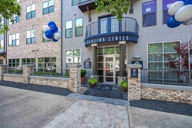 Leasing center entrance with blue white balloons exterior at Villas On Guadalupe in Austin Student Accommodation