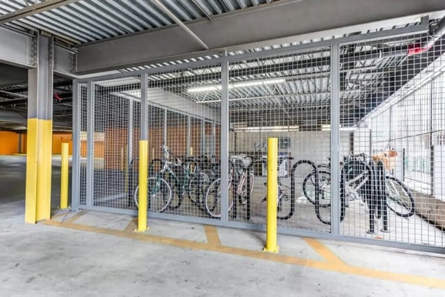 Bicycles inside a caged bicycle storage area. at Villas On Guadalupe in Austin Student Accommodation