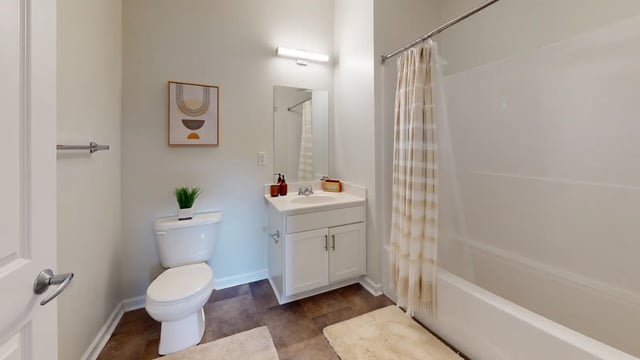 Toilet vanity sink bathtub shower curtain bathroom at The Hill at Rochester in Rochester Student Accommodation