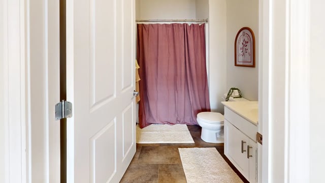 Toilet vanity and shower curtain bathroom at The Hill at Rochester in Rochester Student Accommodation