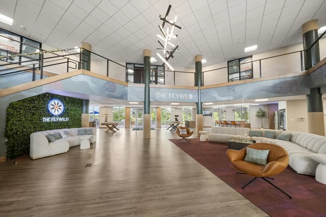 Modern lounge area with curved sofas and chairs common area at The Hill at Rochester in Rochester Student Accommodation