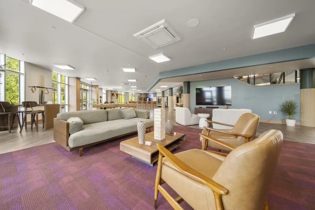 Sofa chairs coffee table and Jenga game lounge at The Hill at Rochester in Rochester Student Accommodation