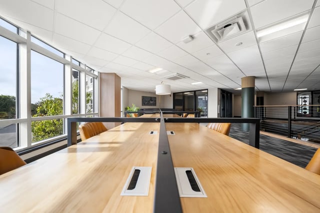 Wood tables with chairs near windows study area at The Hill at Rochester in Rochester Student Accommodation