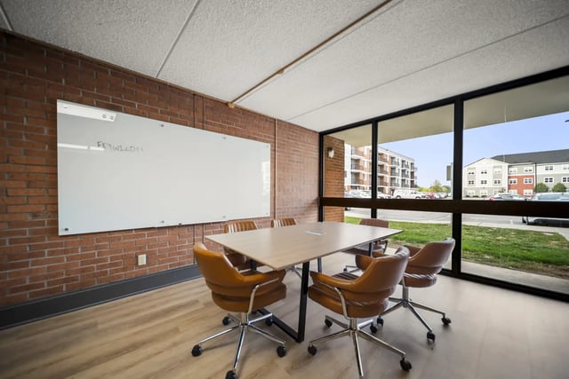 Table with chairs and whiteboard Meeting room at The Hill at Rochester in Rochester Student Accommodation