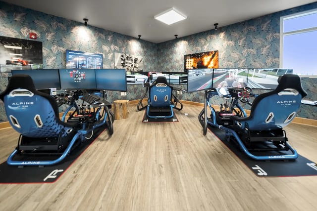Racing simulators with triple monitors and racing seats Gaming area at The Hill at Rochester in Rochester Student Accommodation