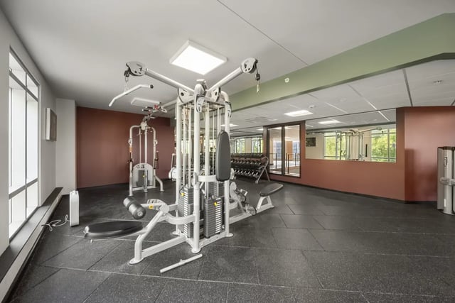 Weight machines dumbbells and mirrors gym at The Hill at Rochester in Rochester Student Accommodation