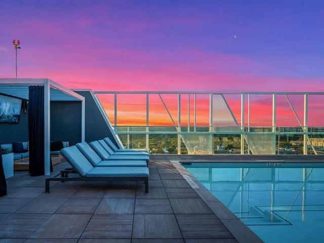 Pool lounge chairs and pool exterior at Villas on Rio in Austin Student Accommodation