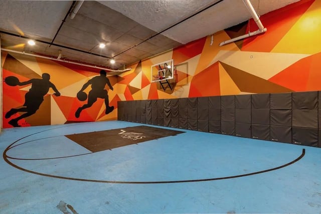 Basketball court with murals playing area at Villas on Rio in Austin Student Accommodation