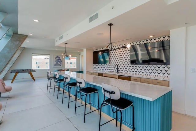 Foosball table bar stools two TVs entertainment area at Villas on Rio in Austin Student Accommodation