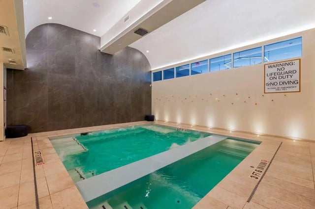 Indoor swimming pool with lights and tiled walls swimming pool at Villas on Rio in Austin Student Accommodation