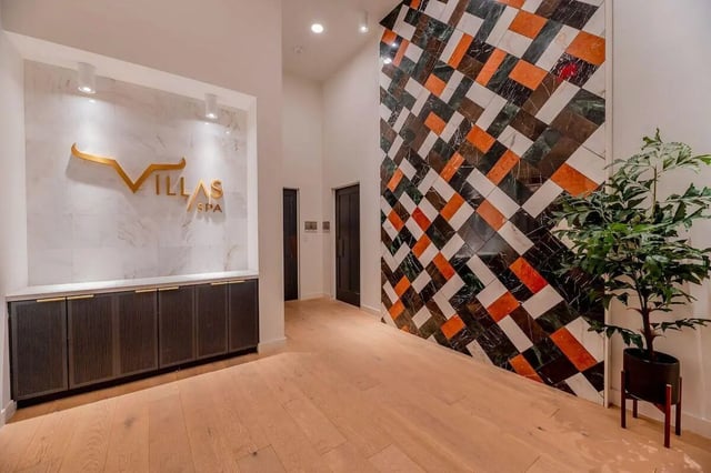 Villas Spa sign cabinets plant lobby at Villas on Rio in Austin Student Accommodation