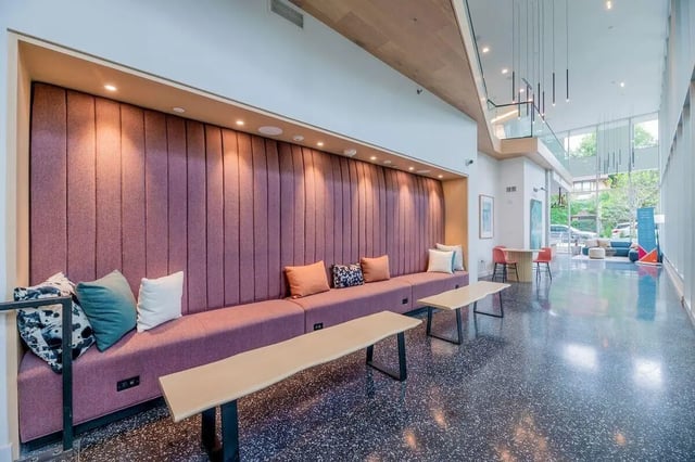 Purple built-in sofa with pillows communal seating area at Villas on Rio in Austin Student Accommodation