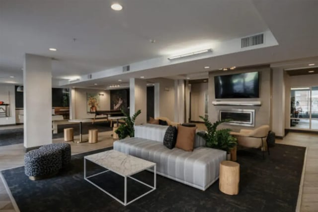Sofa fireplace television and coffee table living room at The Pavilion at North Grounds Apartments in Charlottesville Student Accommodation