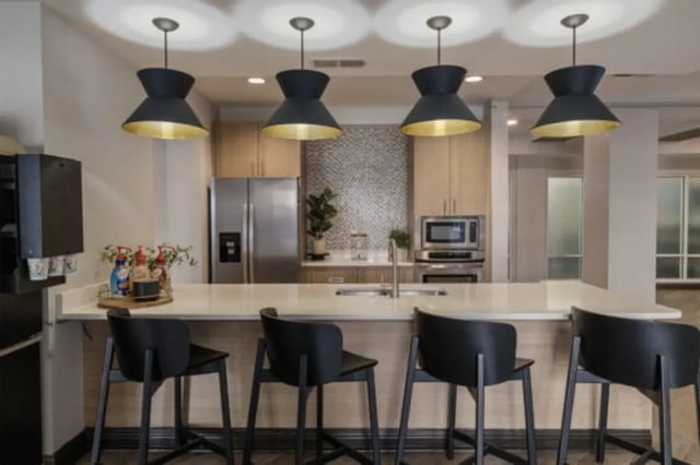 Four black stools at white counter kitchen at The Pavilion at North Grounds Apartments in Charlottesville Student Accommodation