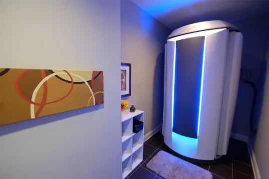 Tanning bed and shelving unit with art Living room at The Pavilion at North Grounds Apartments in Charlottesville Student Accommodation