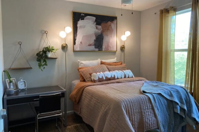 Bed desk plant art bedside lamps bedroom at The Pavilion at North Grounds Apartments in Charlottesville Student Accommodation