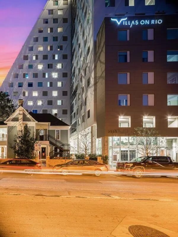 Modern buildings cars and street at twilight exterior at Villas on Rio in Austin Student Accommodation