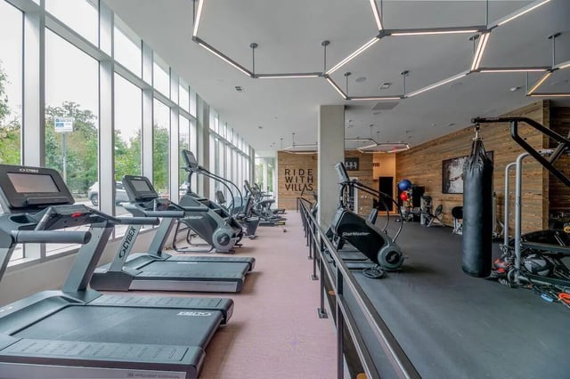 Treadmills stair climbers punching bag gym fitness room at Villas on Rio in Austin Student Accommodation