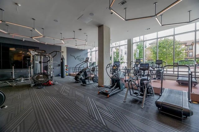 Gym with treadmills ellipticals and weights exterior at Villas on Rio in Austin Student Accommodation
