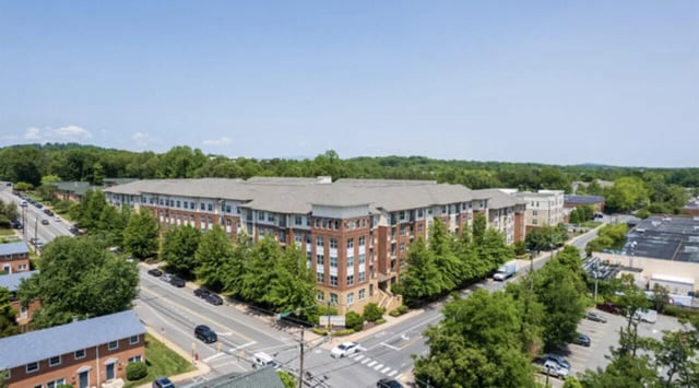Apartment complex with trees and cars exterior at The Pavilion at North Grounds Apartments in Charlottesville Student Accommodation