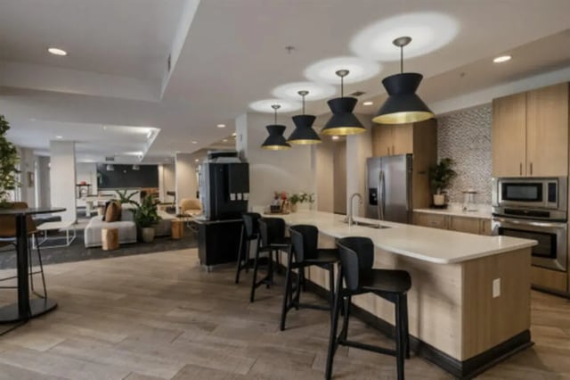 Modern kitchen island bar stools and appliances kitchen at The Pavilion at North Grounds Apartments in Charlottesville Student Accommodation