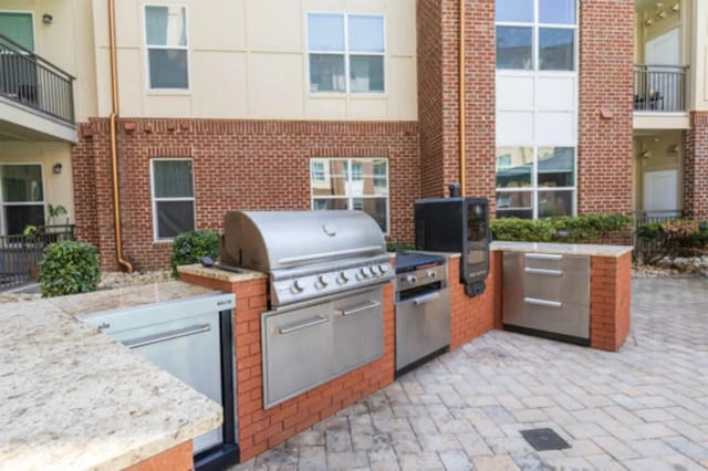 Grill smoker refrigerator outdoor kitchen area exterior at The Pavilion at North Grounds Apartments in Charlottesville Student Accommodation
