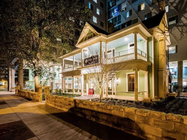 Light green house with balconies exterior at Villas on Rio in Austin Student Accommodation