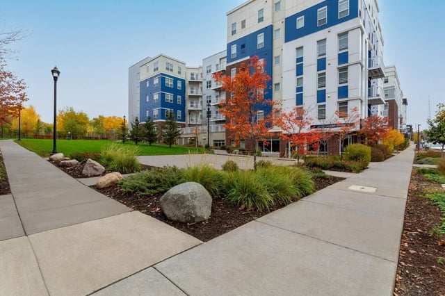 Modern buildings with blue accents and autumn trees Exterior at 44 North in Minneapolis Student Accommodation