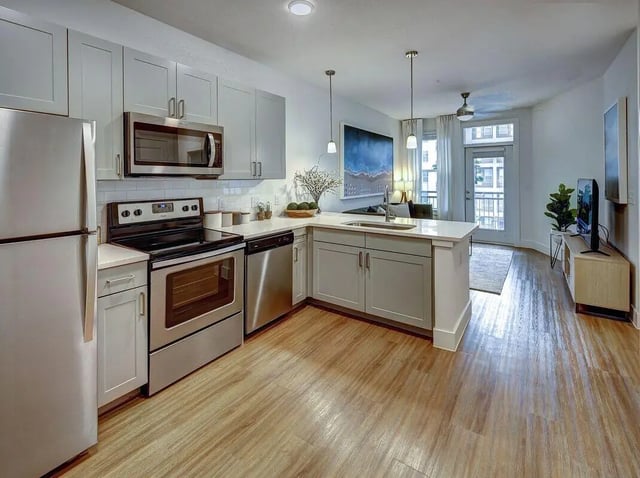 Modern kitchen with stainless steel appliances and island kitchen at The Lyndon in San Marcos Student Accommodation