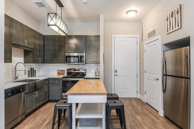 Modern kitchen with island dishwasher stove and fridge kitchen at Aero on 24th in Gainesville Student Accommodation