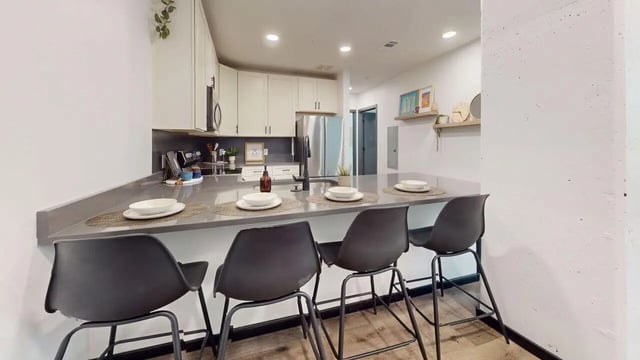 Bar stools at kitchen counter with place settings Kitchen at The Hive in Atlanta Student Accommodation