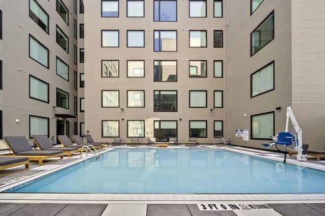 Swimming pool with lounge chairs and building exterior pool at The Hive in Atlanta Student Accommodation