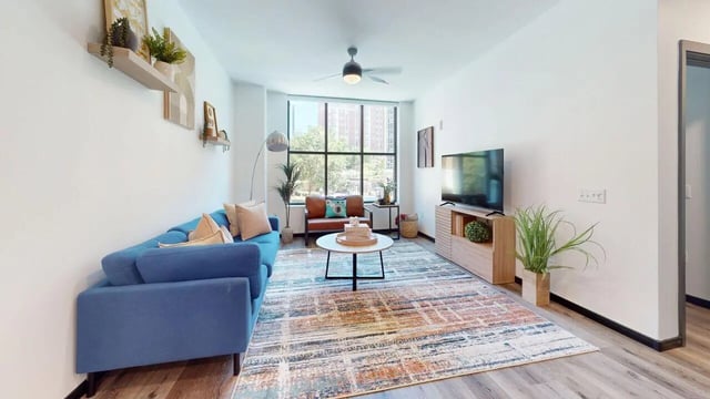 Blue sofa coffee table and TV living room at The Hive in Atlanta Student Accommodation