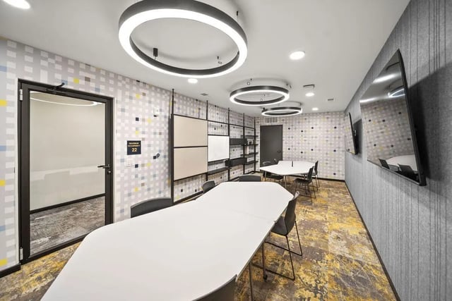 Modern meeting room with white tables and chairs at The Hive in Atlanta Student Accommodation