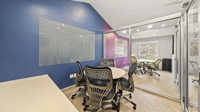 Round table with chairs glass board study area at Station 42 in Tampa Student Accommodation
