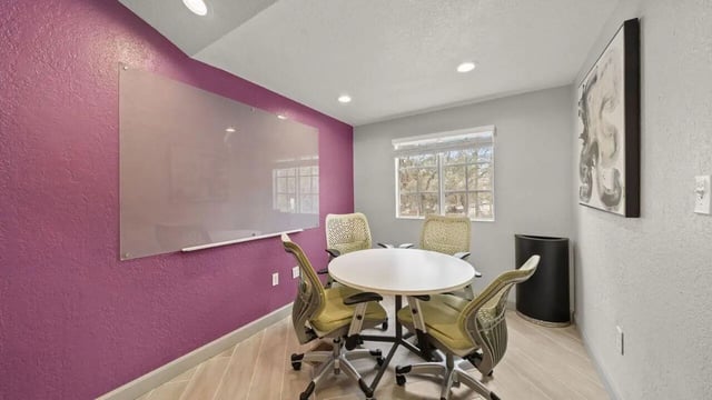 White table four chairs large whiteboard study area at Station 42 in Tampa Student Accommodation