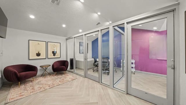Modern seating and glass-walled study rooms lounge at Station 42 in Tampa Student Accommodation