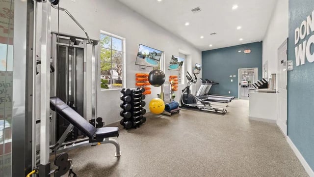 Weights machines treadmills and elliptical gym room at Station 42 in Tampa Student Accommodation